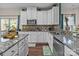 Well-lit kitchen with granite countertops, stainless steel appliances, and wooden floors at 12302 Volusia Ct, Charlotte, NC 28262