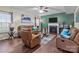 Cozy living room with leather furniture, a fireplace, and hardwood floors for a welcoming ambiance at 12302 Volusia Ct, Charlotte, NC 28262