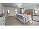 Bright main bedroom with a tufted headboard, neutral color palette and en-suite bathroom at 12302 Volusia Ct, Charlotte, NC 28262