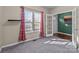 Carpeted office with natural light, neutral walls, and a glass door leading to the foyer at 12302 Volusia Ct, Charlotte, NC 28262