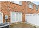 Brick backyard features a white fence, a pair of french doors, and a gravel area at 1310 Green Oaks Ln # H, Charlotte, NC 28205