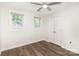 Bright bedroom with hardwood floors, a ceiling fan, and large windows for natural light at 1310 Green Oaks Ln # H, Charlotte, NC 28205
