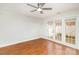 Bright bedroom featuring wood floors and a ceiling fan with french doors to the outside at 1310 Green Oaks Ln # H, Charlotte, NC 28205