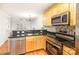 Contemporary kitchen showcasing stainless steel appliances, stone countertops, and mosaic tile backsplash at 1310 Green Oaks Ln # H, Charlotte, NC 28205