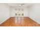 Bright living room with hardwood floors, brick accent wall, and access to the outdoors through sliding glass doors at 1310 Green Oaks Ln # H, Charlotte, NC 28205