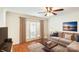 Cozy living room with hardwood floors, a ceiling fan, and access to a balcony at 1310 Green Oaks Ln # H, Charlotte, NC 28205