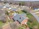 Charming brick home featuring a backyard pool and patio area and mature landscaping at 1529 Indian Springs Nw Dr, Conover, NC 28613