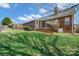 View of the screened porch, stairs, brick facade, and lush lawn at 1529 Indian Springs Nw Dr, Conover, NC 28613