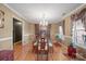Formal dining room featuring hardwood floors, chandelier lighting and a large glass table at 1529 Indian Springs Nw Dr, Conover, NC 28613