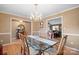 Formal dining room featuring hardwood floors, chandelier lighting and a large glass table at 1529 Indian Springs Nw Dr, Conover, NC 28613