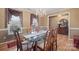 Formal dining room featuring hardwood floors, chandelier lighting and a large glass table at 1529 Indian Springs Nw Dr, Conover, NC 28613