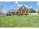 Charming brick home featuring a well-manicured lawn, classic shutters, and a welcoming front porch at 1529 Indian Springs Nw Dr, Conover, NC 28613