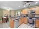 Well-lit kitchen featuring stainless steel appliances, granite countertops, and an adjacent dining area at 1529 Indian Springs Nw Dr, Conover, NC 28613