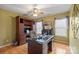 Well-lit home office featuring a built-in bookcase, wood desk, and hardwood floors, creating a professional workspace at 1529 Indian Springs Nw Dr, Conover, NC 28613