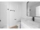White bathroom with black fixtures, vanity and walk-in shower at 1611 Carlton Ave, Kannapolis, NC 28083