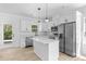 Bright, modern kitchen with white cabinets, stainless steel appliances, and quartz countertops at 1611 Carlton Ave, Kannapolis, NC 28083