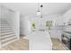 Open kitchen with a central island and view of the stairs at 1611 Carlton Ave, Kannapolis, NC 28083
