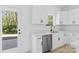 Well-lit kitchen area with white cabinets, stainless steel appliances, and wood-look flooring at 1615 Carlton Ave, Kannapolis, NC 28083