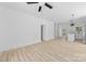 Spacious living room with wood-look floors, ceiling fan, and ample natural light at 1615 Carlton Ave, Kannapolis, NC 28083