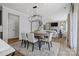 Open-concept dining room flowing into living room with fireplace and view of staircase at 2133 Moss Bluff Dr, Mint Hill, NC 28227