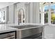 Close-up of a stainless steel farmhouse sink under a window showing the outdoors at 2133 Moss Bluff Dr, Mint Hill, NC 28227