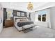 The main bedroom is spacious with natural light, stylish decor, and a tray ceiling at 2133 Moss Bluff Dr, Mint Hill, NC 28227
