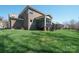 Backyard with a lush green lawn and brick home at 224 Alexandria Dr, Mooresville, NC 28115