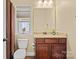 Bathroom featuring a wooden vanity with a granite countertop, and natural lighting through a window at 224 Alexandria Dr, Mooresville, NC 28115