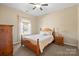 Bedroom featuring neutral walls, carpet floors and a queen size bed with views to the outside at 224 Alexandria Dr, Mooresville, NC 28115