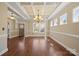 Bright dining area featuring hardwood floors, a chandelier, and large windows for natural light at 224 Alexandria Dr, Mooresville, NC 28115