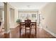 Well-lit dining room with hardwood floors, a modern chandelier, and ample seating at 224 Alexandria Dr, Mooresville, NC 28115