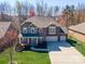 Attractive two-story home with a two-car garage, green lawn, and covered front porch at 224 Alexandria Dr, Mooresville, NC 28115