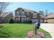 Beautiful brick home with a three-car garage, well-manicured lawn, and charming front porch at 224 Alexandria Dr, Mooresville, NC 28115