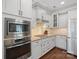 Modern kitchen featuring stainless steel appliances, white cabinets, and granite countertops at 224 Alexandria Dr, Mooresville, NC 28115