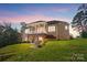 Spacious backyard with a covered deck, patio area, and lush greenery, perfect for outdoor entertaining and relaxation at 226 Hermance Ln, Mooresville, NC 28117