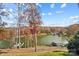 Picturesque backyard with a view of the lake and dock, surrounded by trees at 226 Hermance Ln, Mooresville, NC 28117