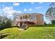 Spacious backyard with a covered deck, patio area, and lush greenery, perfect for outdoor entertaining and relaxation at 226 Hermance Ln, Mooresville, NC 28117