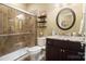 Bathroom with glass enclosed shower, tile surround, granite countertops, and decorative shelves at 226 Hermance Ln, Mooresville, NC 28117