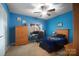 Cozy bedroom with blue walls, ceiling fan, and natural light showcases a comfortable living space at 226 Hermance Ln, Mooresville, NC 28117