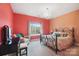 Charming bedroom with decorative chandelier, large window, and vibrant color scheme at 226 Hermance Ln, Mooresville, NC 28117