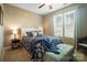 Cozy bedroom features blue accents, carpet, ceiling fan, and well-lit windows at 226 Hermance Ln, Mooresville, NC 28117