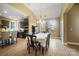 Bright dining area adjacent to kitchen has wood flooring, a vaulted ceiling, and large windows with beautiful views at 226 Hermance Ln, Mooresville, NC 28117