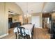 The dining area is adjacent to a living room and kitchen and features tile floors and a modern chandelier at 226 Hermance Ln, Mooresville, NC 28117