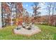 Inviting fire pit area with seating, offering a cozy outdoor space to enjoy the lake views and natural surroundings at 226 Hermance Ln, Mooresville, NC 28117