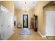 Bright foyer featuring a decorative chandelier, tile floors, and an elegant front door with glass detailing at 226 Hermance Ln, Mooresville, NC 28117