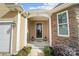 Inviting front entrance with stone and tan siding, decorative front door, and well-maintained landscaping at 226 Hermance Ln, Mooresville, NC 28117