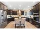 Modern kitchen featuring dark cabinets, granite countertops, stainless steel appliances, and a center island at 226 Hermance Ln, Mooresville, NC 28117