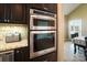Modern kitchen with stainless steel appliances, including a double oven and built-in microwave, with a view to the dining area at 226 Hermance Ln, Mooresville, NC 28117