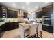 Modern kitchen with dark cabinetry, granite countertops, stainless steel appliances, and a central island at 226 Hermance Ln, Mooresville, NC 28117