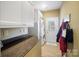 Well-lit laundry room with washer, dryer, folding counter, wood floors, and access to the exterior at 226 Hermance Ln, Mooresville, NC 28117